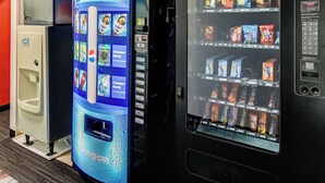 A vending machine with a Pepsi advertisement and a selection of snacks.