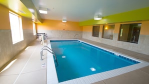 An indoor swimming pool with clear water, a diving board, and a lifeguard chair. - Red Roof Inn Springfield, OH (Springfield)