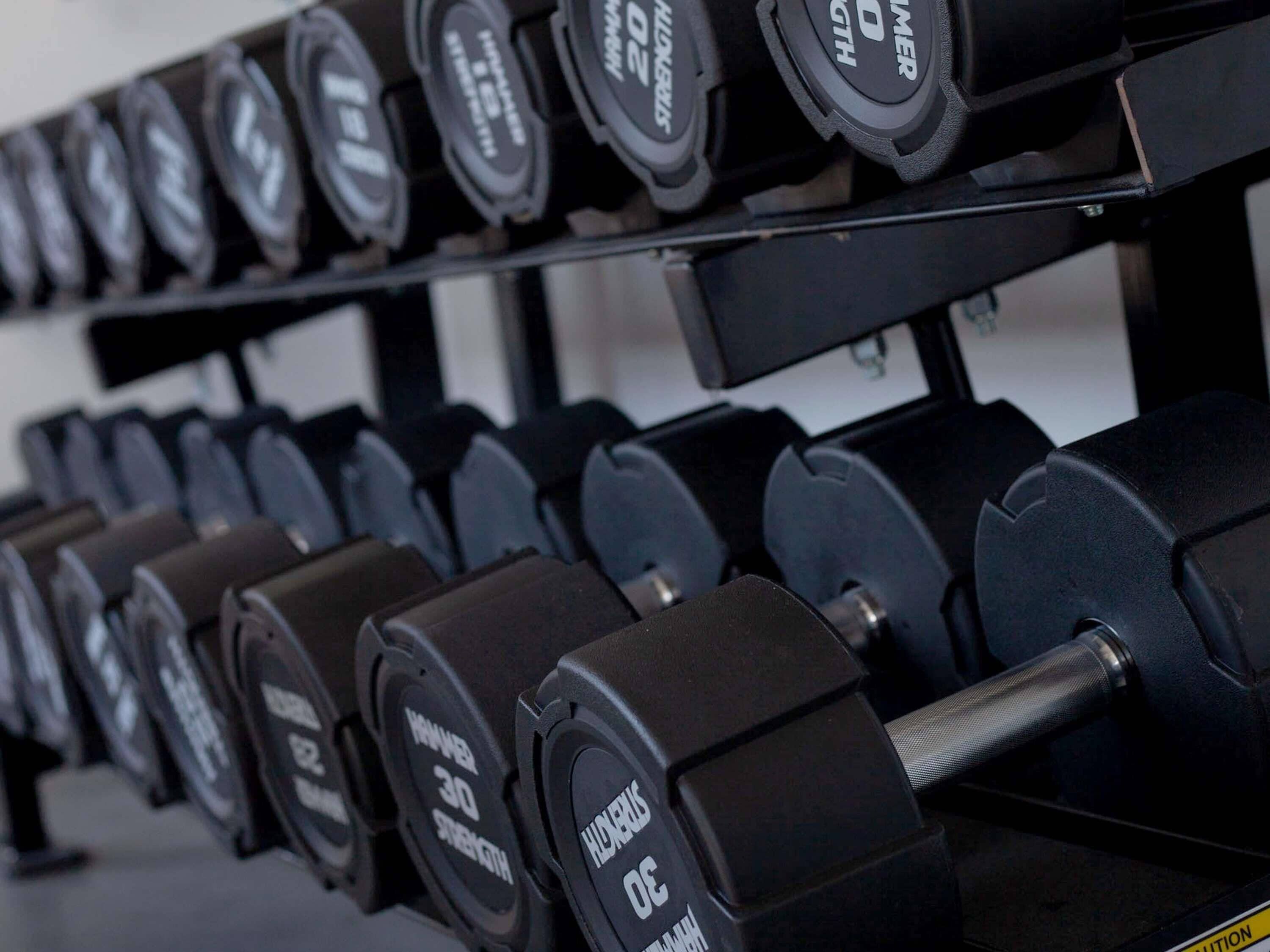 A rack of dumbbells with weights labeled 5, 10, 15, 20, and 25 kg.