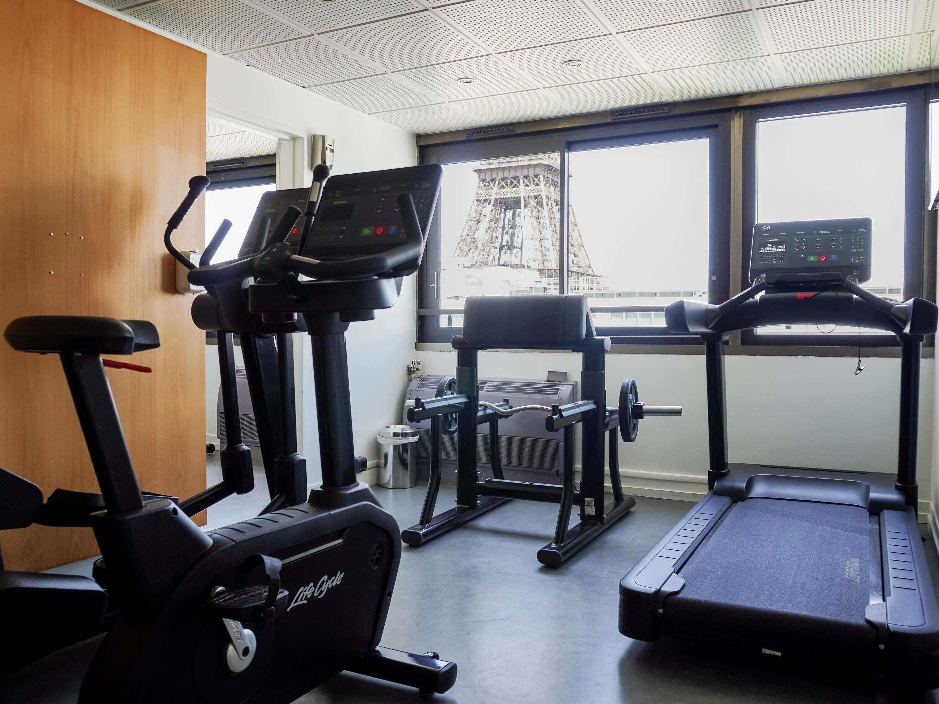 A gym with treadmills, an elliptical, and a weight machine.