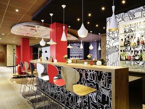 A modern bar area with red and black decor, multiple hanging pendant lights, and a variety of bar stools. - ibis Hamburg Alster Centrum (Hamburg)
