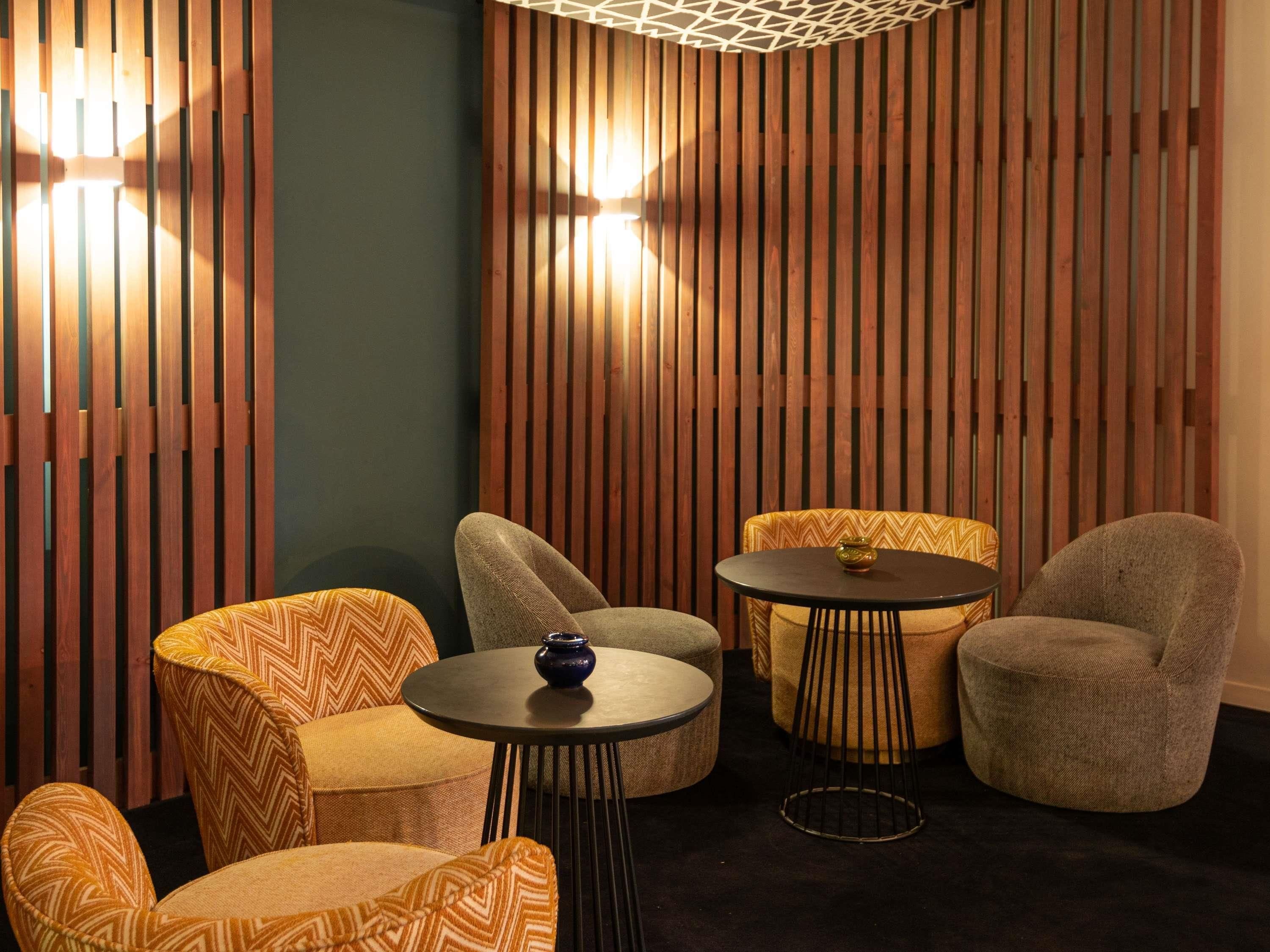 A cozy seating area with wooden slats, a patterned sofa, and a small table with a decorative item.