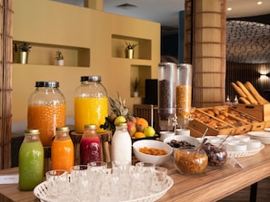 A buffet with various food items and beverages, including fruits, pastries, and a coffee station. - Hotel ibis Marrakech Centre Gare (Marrakech)