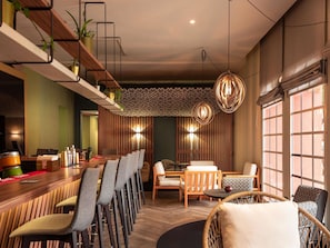 A modern interior with a bar area, seating, and decorative lighting. - Hotel ibis Marrakech Centre Gare (Marrakech)