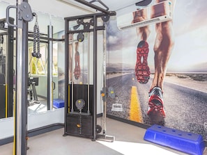 Stay active with our fully equipped gym featuring a cable machine and squat rack.