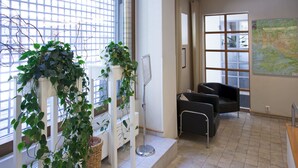 A modern waiting area with a large window, a map on the wall, and a reception desk. - Scandic Plaza Turku (Turku)