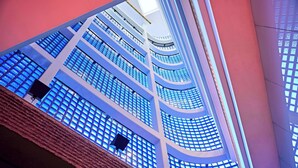 A multi-level atrium with a modern design, featuring a series of balconies and a central open space. - Lindner Hotel Cologne Am Dom, part of JdV by Hyatt (Cologne)
