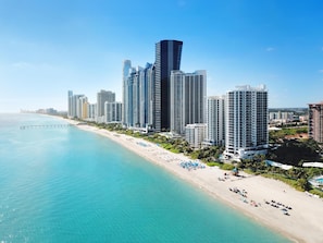 A coastal cityscape with high-rise buildings, a beach, and a pier. - DoubleTree Resort & Spa by Hilton Ocean Point-N. Miami Beach (Sunny Isles Beach)