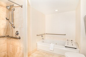 A bathroom with a shower, grab bars, a bathtub, and a toilet. - DoubleTree Resort & Spa by Hilton Ocean Point-N. Miami Beach (Sunny Isles Beach)