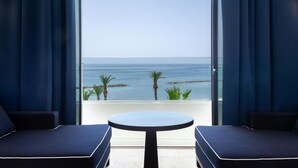 A room with a view of the sea, a round table, and two blue sofas. - Almyra (Paphos)