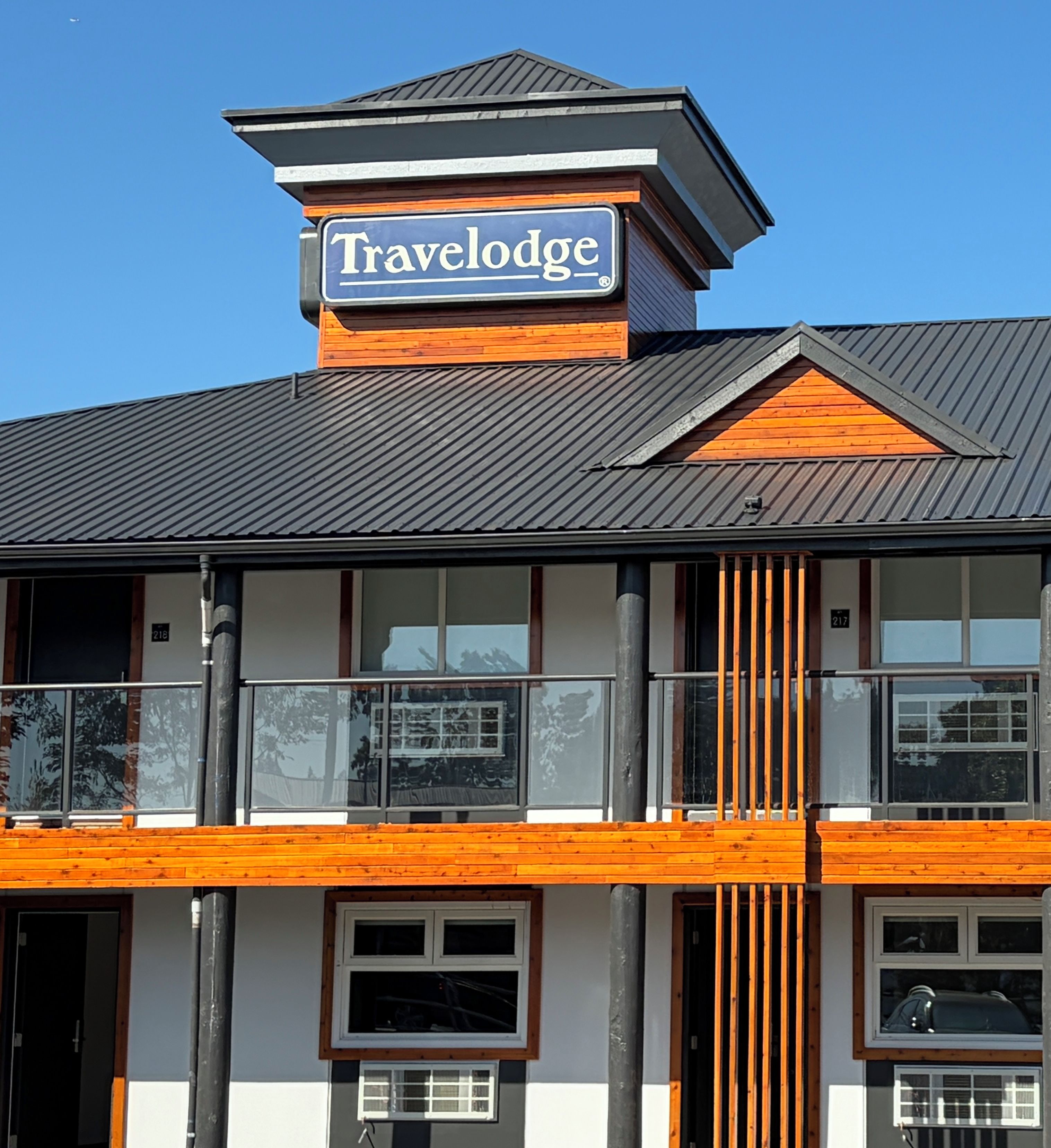 A building with a Travelodge sign, balconies, and a modern architectural design.