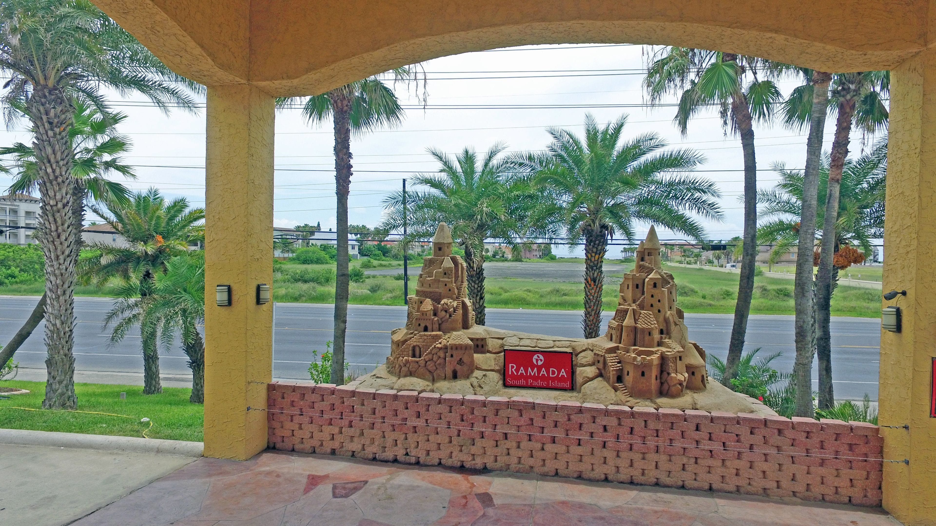 A sandcastle display with a sign reading "Ramada South Padre Island".