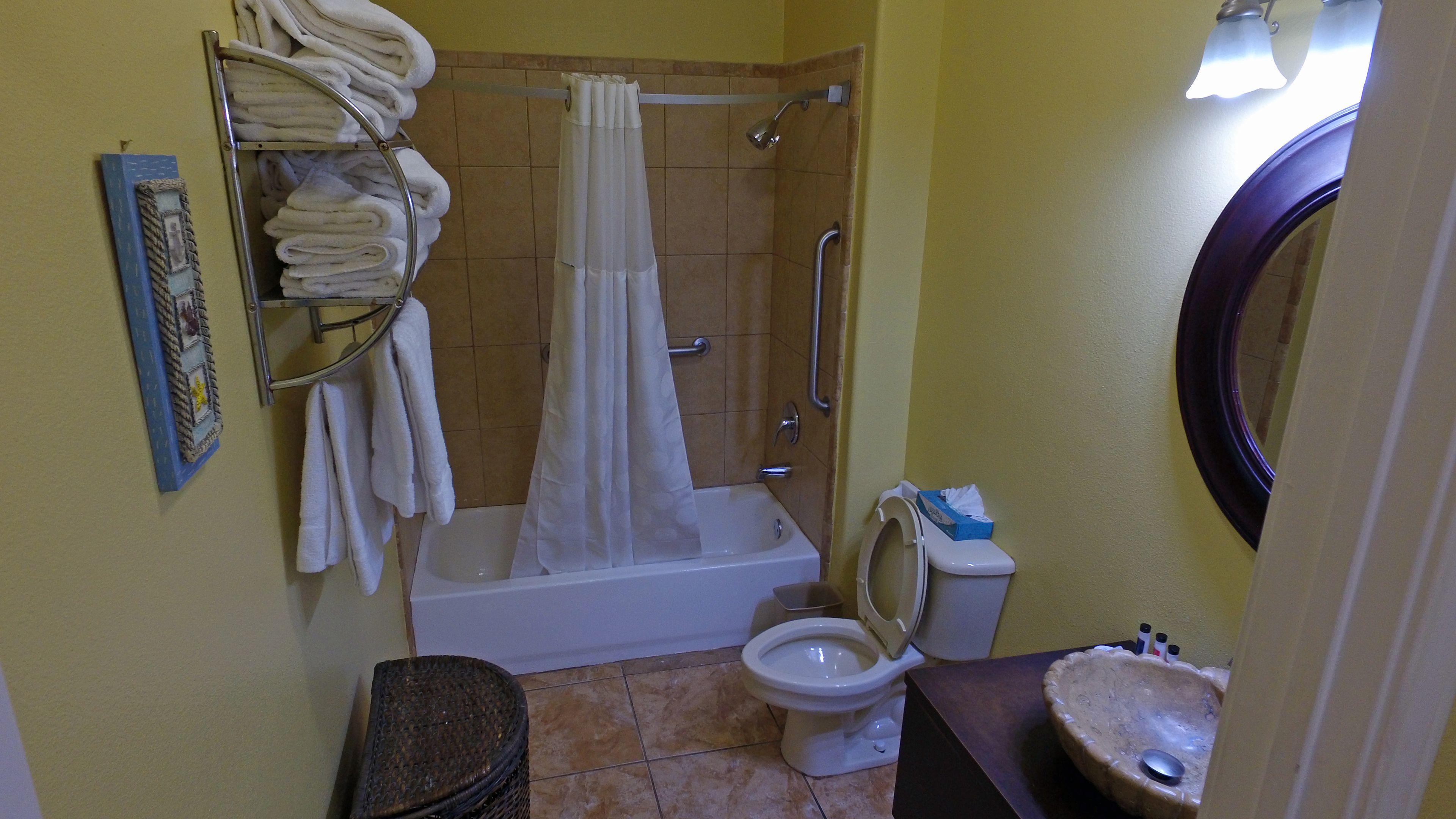 A bathroom with a bathtub, toilet, and sink.