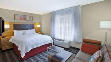 1 habitación, escritorio y tabla de planchar con plancha