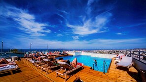 Seasonal outdoor pool, open 10:30 AM to 8:00 PM, pool umbrellas
