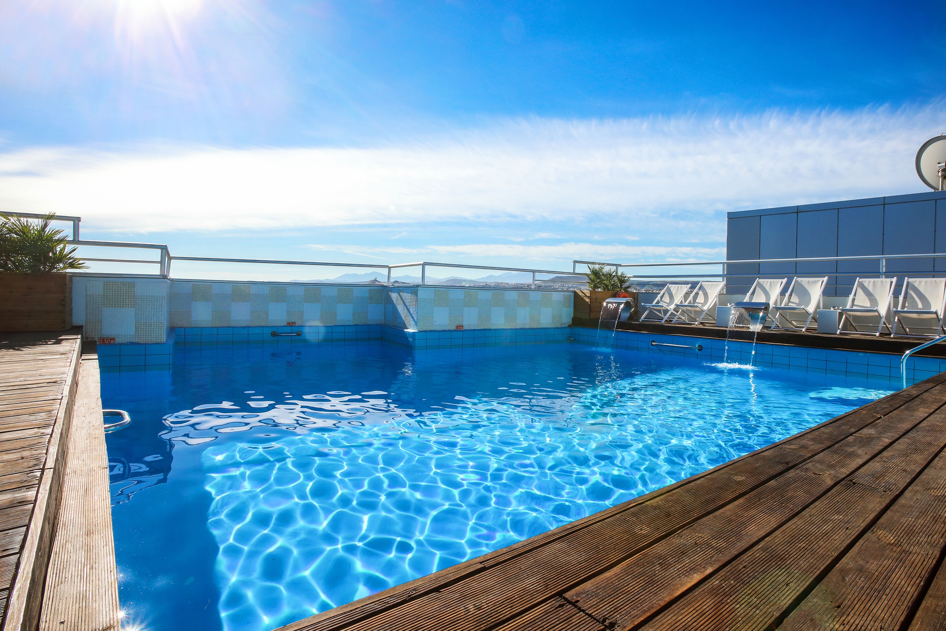 seasonal outdoor pool, open 11:00 am to 8:00 pm, pool umbrellas