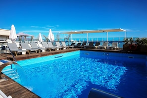 Seasonal outdoor pool, open 11:00 AM to 8:00 PM, pool umbrellas