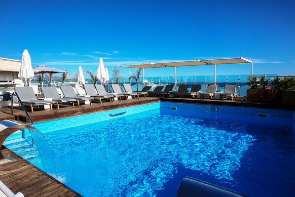 Seasonal outdoor pool, open 11:00 AM to 8:00 PM, pool umbrellas