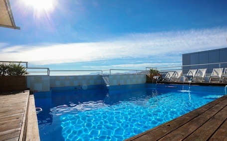 Seasonal outdoor pool, open 11:00 AM to 8:00 PM, pool umbrellas