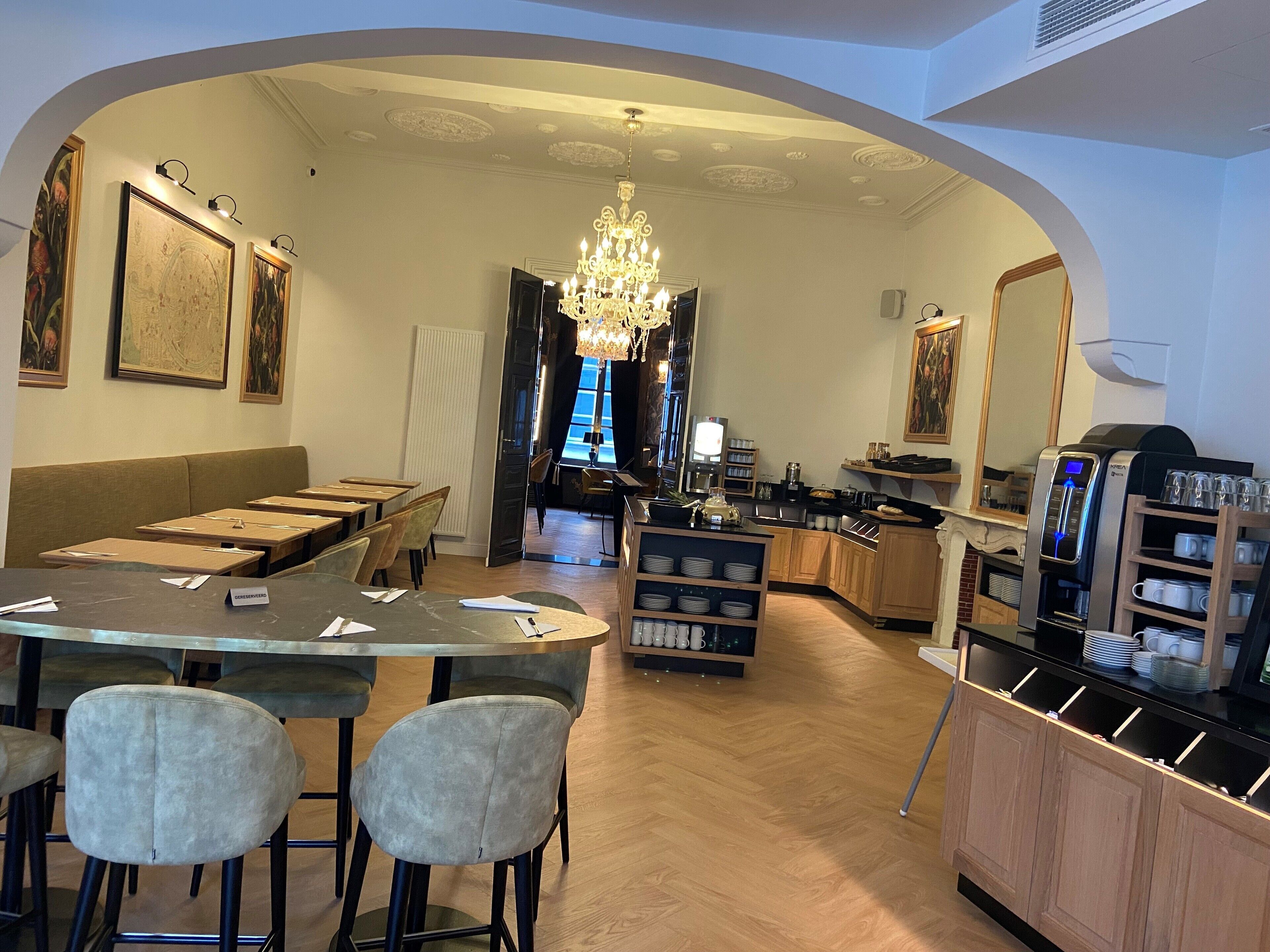 A restaurant with a bar area, seating, and a coffee machine.