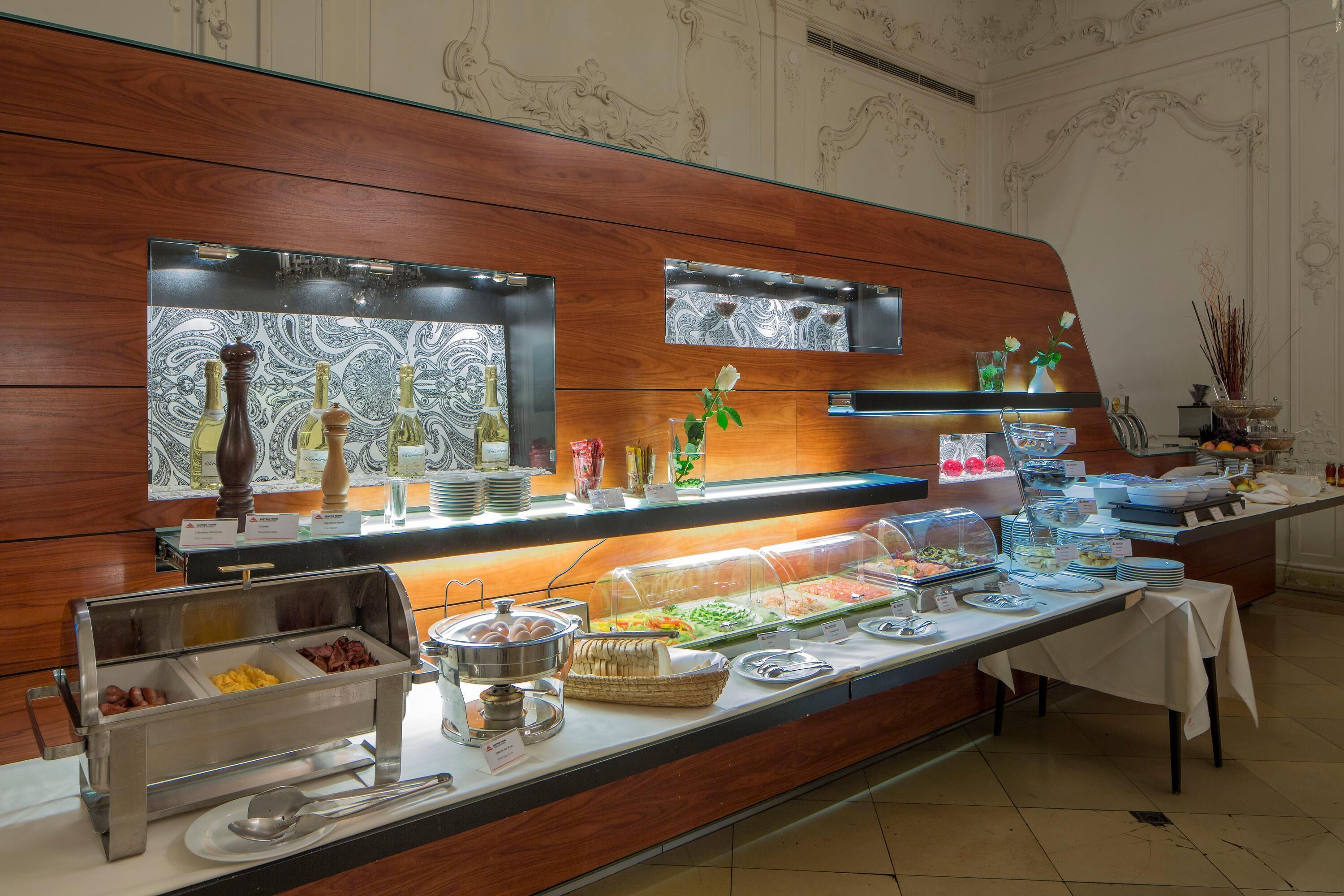 A buffet setup with various food items and condiments.