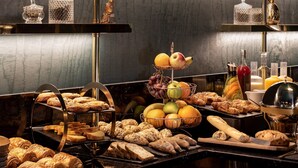A buffet with various breads, pastries, fruits, and beverages. - Maison Nabis by Happyculture (Paris)