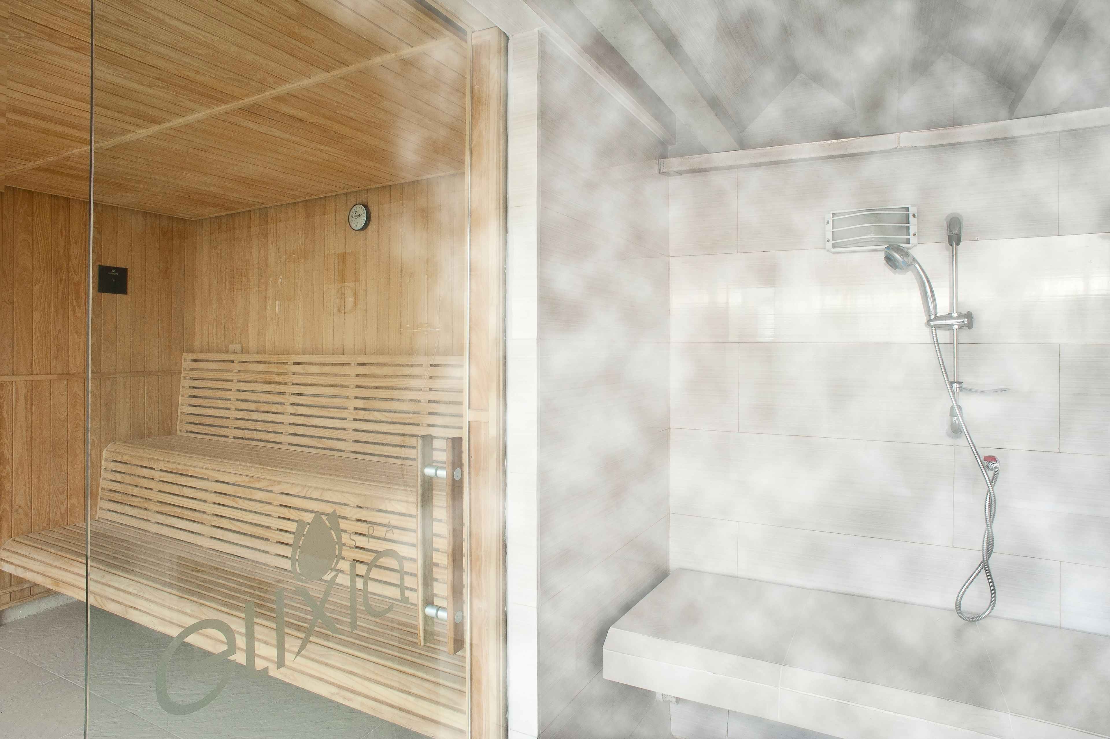 Una sauna con bancos de madera y ducha de vapor.
