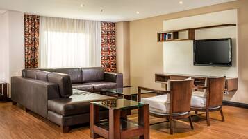 Luxury Suite | Living area | 32-inch LCD TV with satellite channels, TV