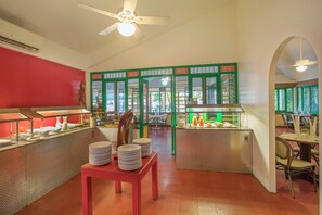A restaurant interior with a buffet area, a dining section, and a ceiling fan. - Whala!boca Chica (Boca Chica)