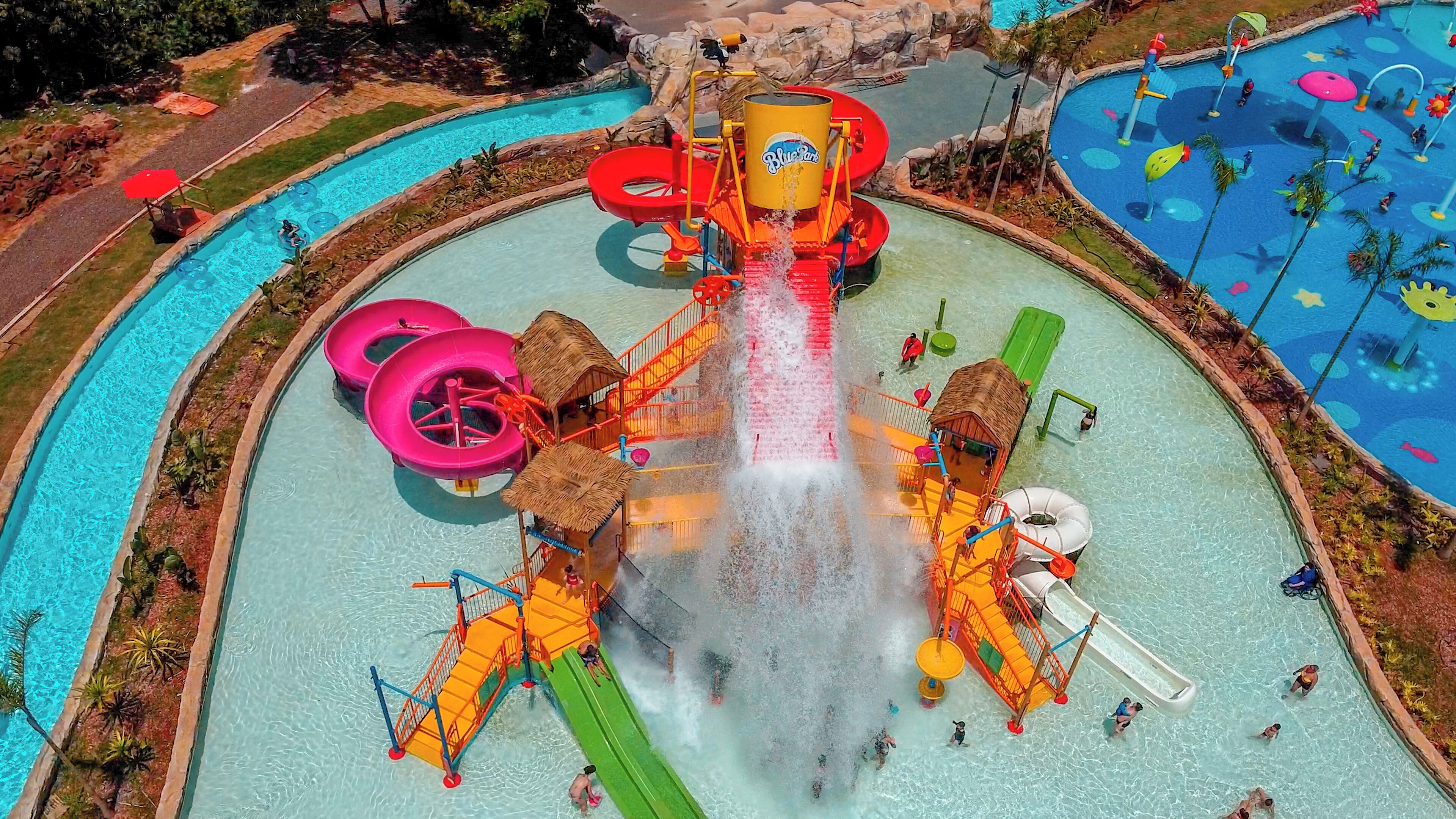 A water park with multiple slides and water features, surrounded by pools.