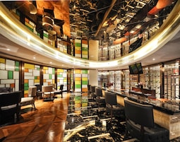 A hotel lobby with a curved ceiling, a shoe display, and a seating area.