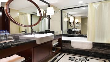 A modern bathroom with a large mirror, a sink, a bathtub, and a shower curtain.