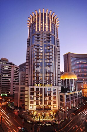 A high-rise hotel with a distinctive cylindrical top, multiple floors, and a central courtyard. - Central Hotel Shanghai (Shanghai)