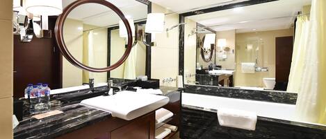 A modern bathroom with a large mirror, a sink, a bathtub, and a shower curtain.
