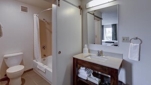 A bathroom with a toilet, bathtub, and sink.