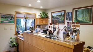 A kitchen with wooden cabinets, a wooden island, and various kitchen items. - Lazy J Ranch Motel (Three Rivers)