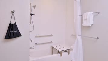 Un baño moderno con ducha, toallero y bolsa para secador.