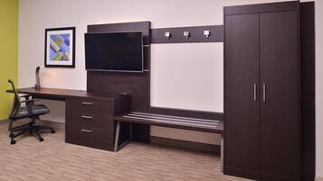 A modern office space with a desk, chair, and wardrobe.
