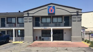 A motel with a '6' sign, a parking lot, and a gated entrance. - Motel 6 El Paso, TX - West (El Paso)