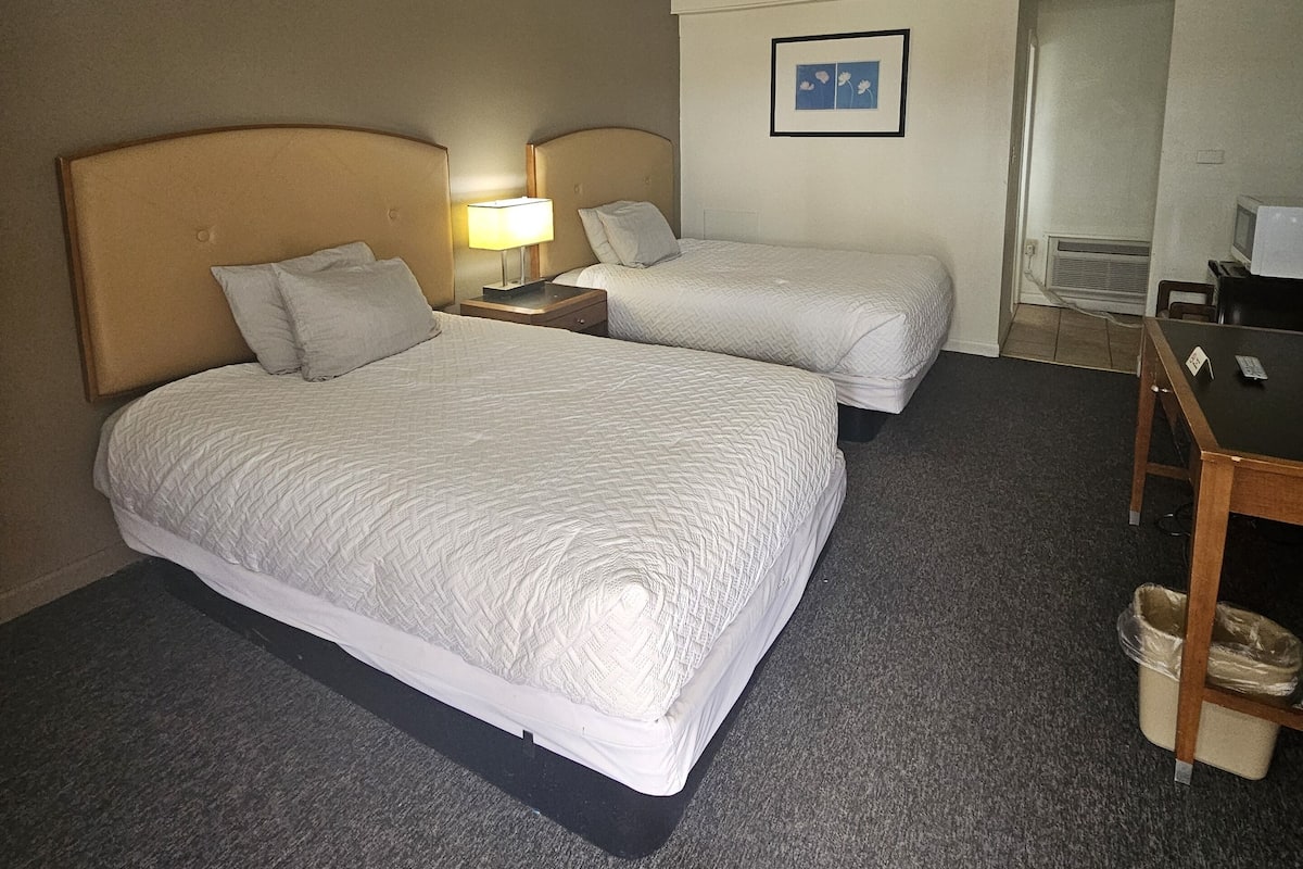 Desk, laptop workspace, iron/ironing board, bed sheets