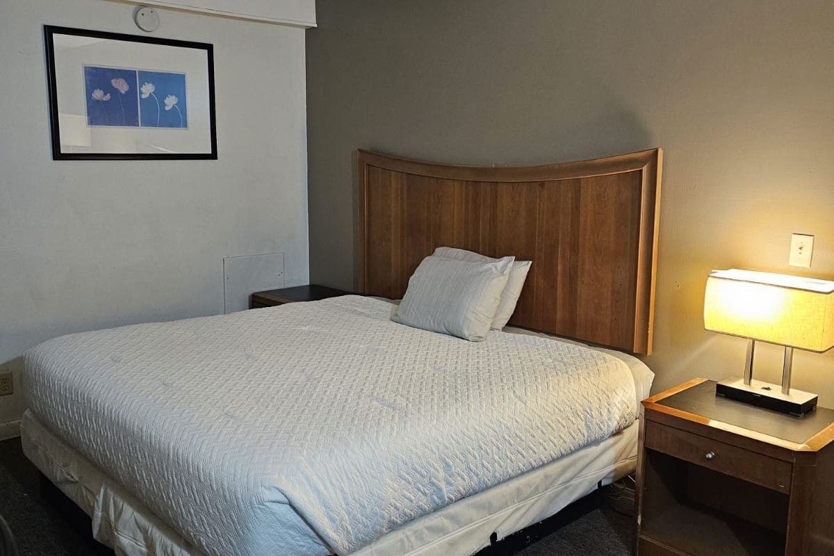 Desk, laptop workspace, iron/ironing board, bed sheets