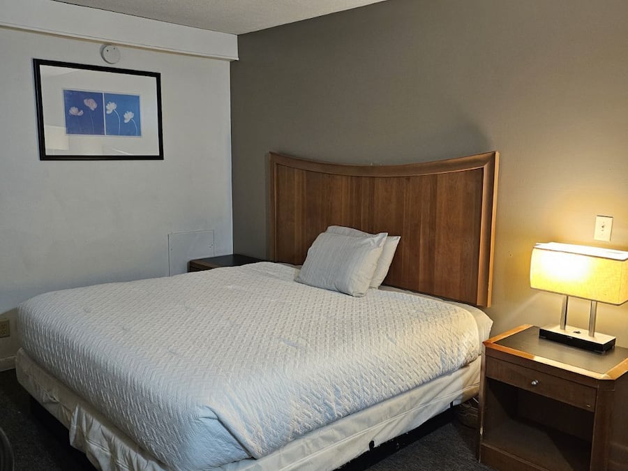 Desk, laptop workspace, iron/ironing board, bed sheets