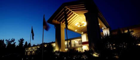 A modern building with a prominent entrance and a large overhang.