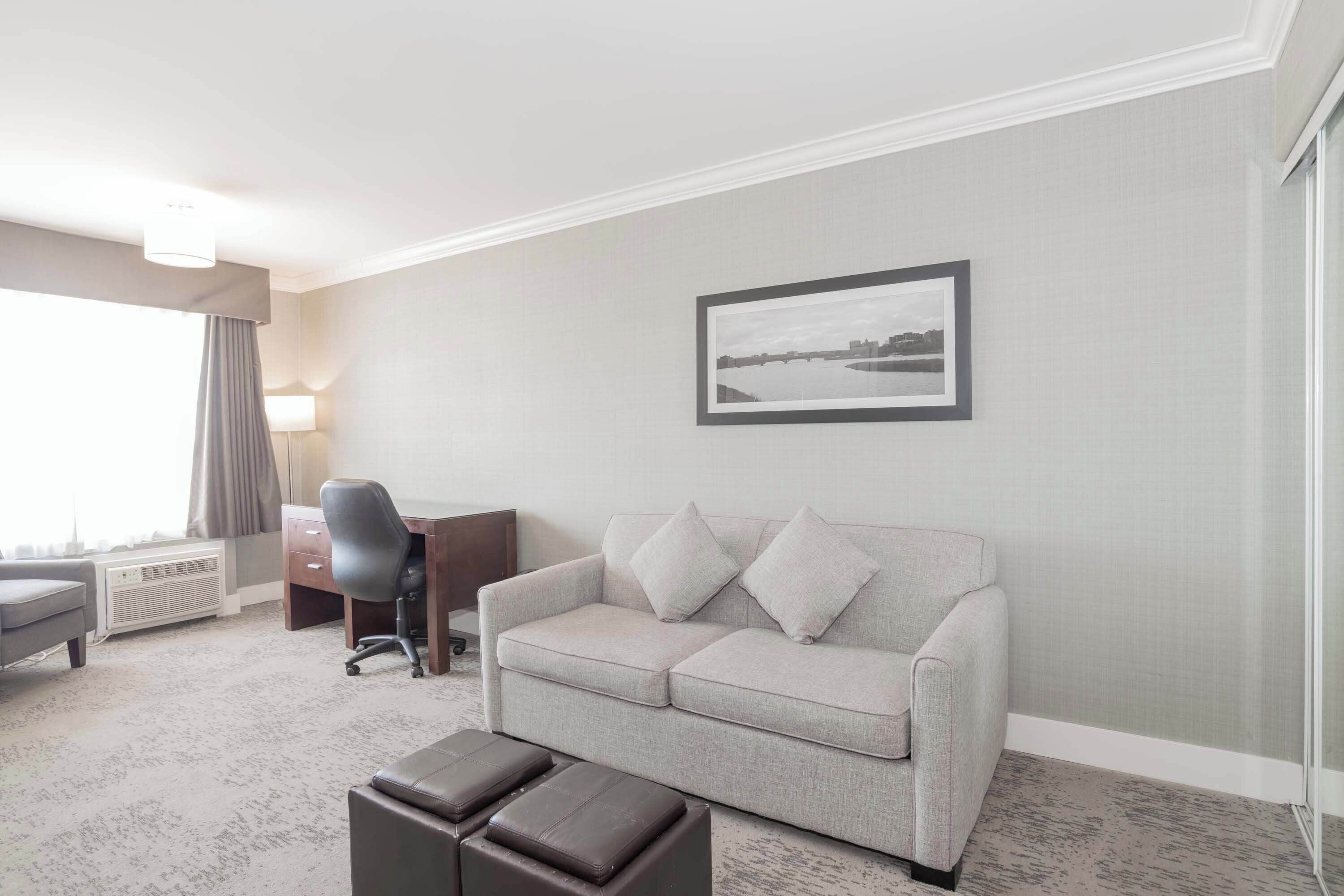 grand suite, 1 king bed with sofa bed, kitchenette | living area | 32-inch flat-screen tv with cable channels, tv