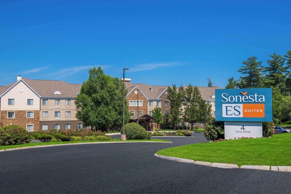 A Sonesta ES Suites hotel with a clear driveway, multiple buildings, and a sign indicating the location on Tech Drive. - Sonesta ES Suites Andover Boston (Andover)