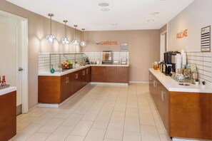 A modern kitchen with a central island, a coffee machine, and a sign that reads "AWAKE". - Sonesta ES Suites Andover Boston (Andover)