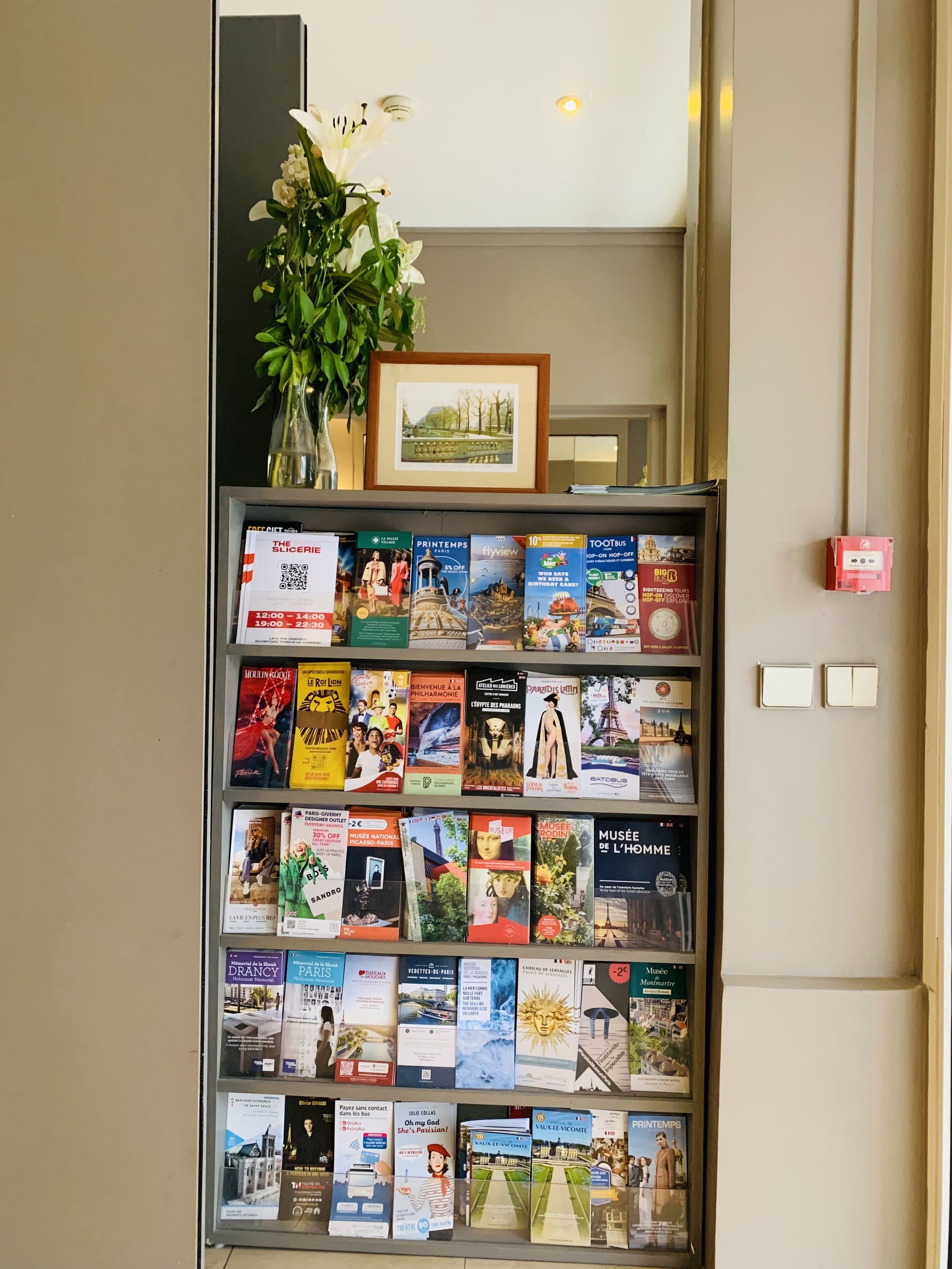 A bookshelf with various travel and cultural magazines.