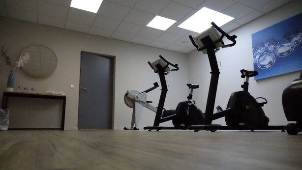 A room with a treadmill, stationary bike, and a desk with a chair. - Relais St Eloi, Sure Hotel Collection by Best Western (Tours)