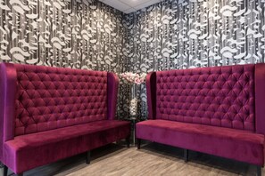 A room with two tufted red sofas, a patterned wall, and a small table with a vase. - Relais St Eloi, Sure Hotel Collection by Best Western (Tours)