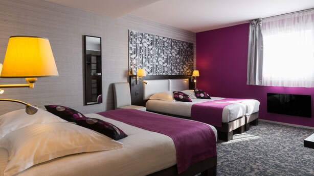 A hotel room with two beds, a large mirror, and a television on the wall. - Relais St Eloi, Sure Hotel Collection by Best Western (Tours)